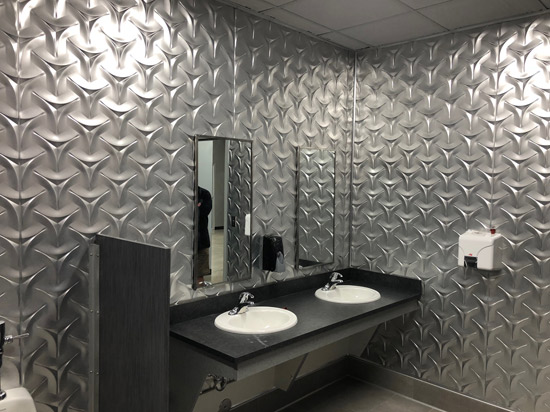Commercial bathroom wall with Japanese MirroFlex panels featuring a sleek, durable, and easy-to-clean design
