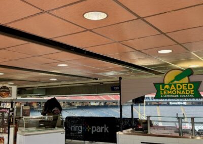 Concession stand area under stadium seating with a sign reading Loaded Lemonade